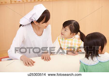 Nursery Teacher and Children Waiting School Lunch View Large Photo Image Picture - Nursery Teacher and Children Waiting School Lunch. Fotosearch