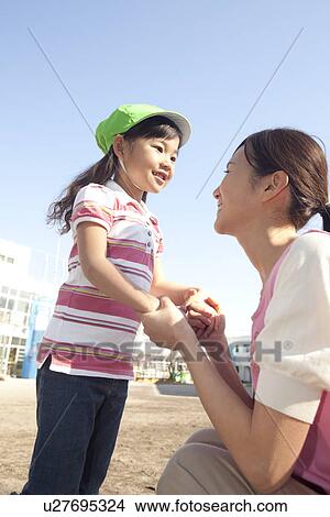 Nursery Teacher and Girl Playing View Large Photo Image Picture - Nursery Teacher and Girl Playing. Fotosearch
