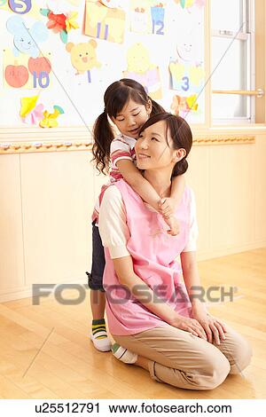 Nursery Teacher and Girl Playing View Large Photo Image Stock Image - Nursery Teacher and Girl Playing. Fotosearch