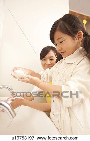 Nursery Teacher and Girl Washing Hands View Large Photo Image Stock Photo - Nursery Teacher and Girl Washing Hands. Fotosearch