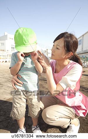 Nursery Teacher Comforting Crying Boy View Large Photo Image Picture - Nursery Teacher Comforting Crying Boy. Fotosearch