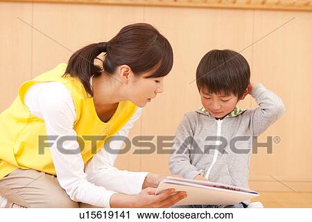 Stock Image - Nursery Teacher Talking to Boy. Fotosearch