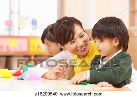 Nursery Teacher Talking to Children View Large Photo Image Stock Image - Nursery Teacher Talking to Children. Fotosearch
