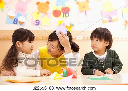 Nursery Teacher Talking to Children View Large Photo Image Stock Image - Nursery Teacher Talking to Children. Fotosearch