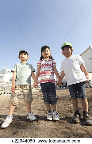 Three Children Standing at Playground View Large Photo Image Stock Image - Three Children Standing at Playground. Fotosearch