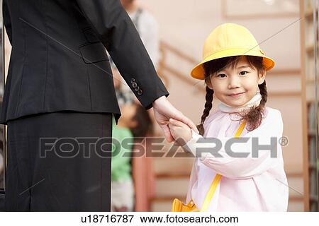 Stock Photo - Working Woman Dropping Daughter off Day-care Center. Fotosearch