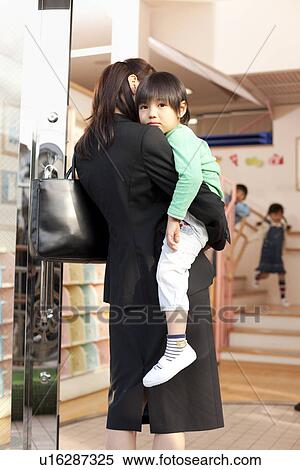 Stock Photography - Working Woman Dropping Son off Day-care Center. Fotosearch