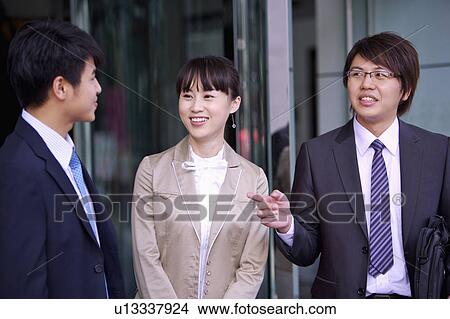 Three colleagues standing and talking together View Large Photo Image Picture - Three colleagues standing and talking together. Fotosearch