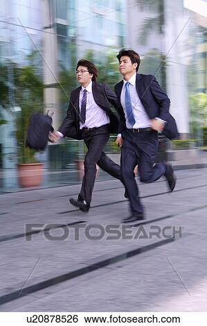 Two businessmen running together View Large Photo Image Stock Photograph - Two businessmen running together. Fotosearch