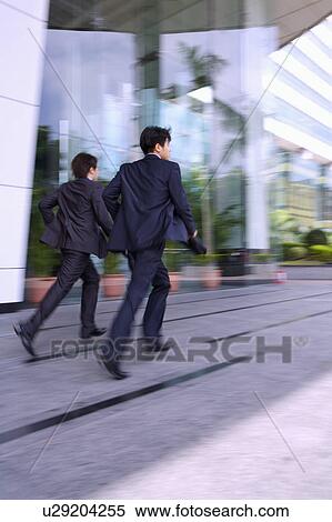 Two businessmen running together View Large Photo Image Stock Photography - Two businessmen running together. Fotosearch