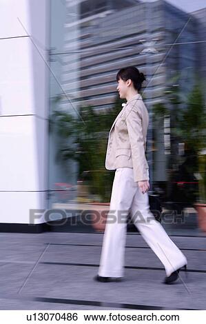 Young businesswoman walking View Large Photo Image Stock Photograph - Young businesswoman walking. Fotosearch
