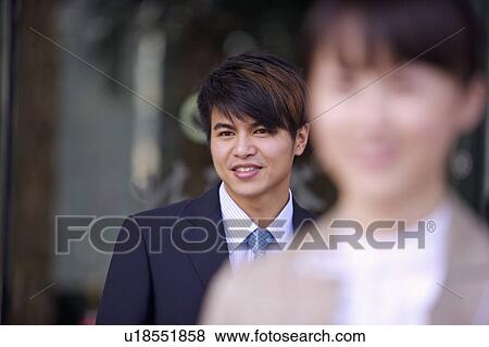 Stock Photo - Young man looking away with smile. Fotosearch