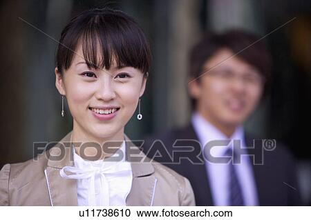 Stock Image - Young woman looking away with smile. Fotosearch