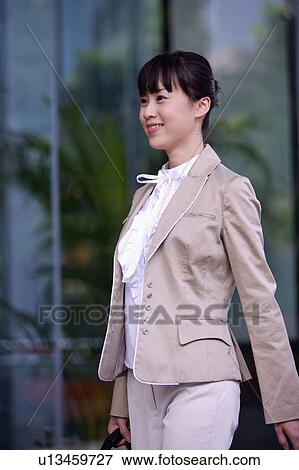 Young woman walking and smiling View Large Photo Image Stock Photo - Young woman walking and smiling. Fotosearch