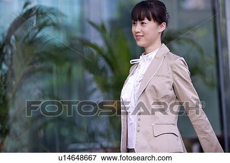 Young woman walking and smiling View Large Photo Image Stock Photo - Young woman walking and smiling. Fotosearch