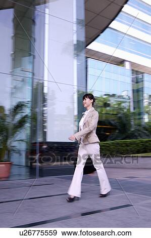 Young woman walking View Large Photo Image Stock Photo - Young woman walking. Fotosearch