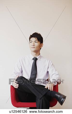 Stock Photograph - Businessman sitting in an armchair and thinking. Fotosearch