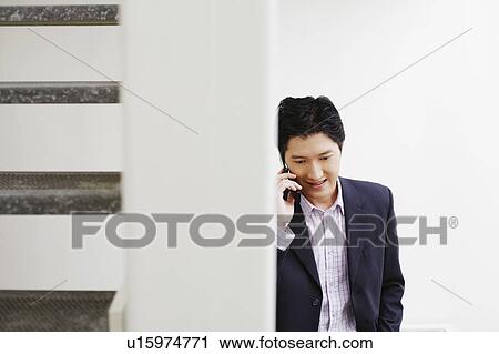 Stock Image - Businessman talking on a mobile phone. Fotosearch