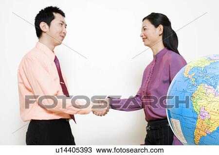 Businesswoman shaking hands with a businessman View Large Photo Image Stock Image - Businesswoman shaking hands with a businessman. Fotosearch