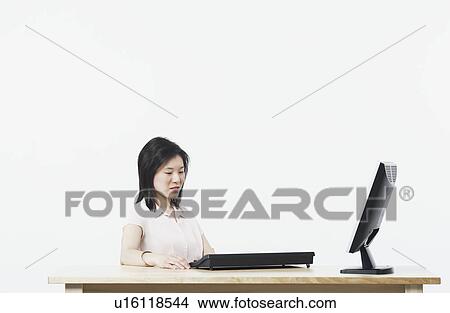 Picture - Businesswoman using a computer. Fotosearch