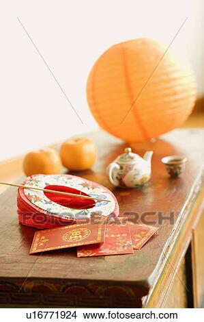 Picture - Chinese lantern and a kettle with envelopes on the table. Fotosearch