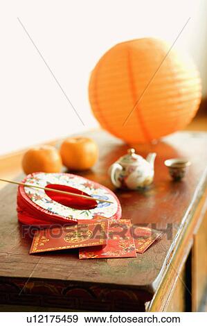 Stock Photo - Chinese lantern and a kettle with envelopes on the table. Fotosearch