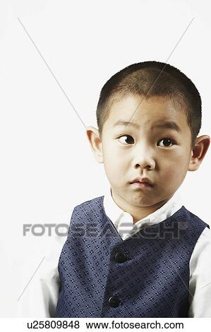 Close-up of a boy looking away View Large Photo Image Stock Photo - Close-up of a boy looking away. Fotosearch