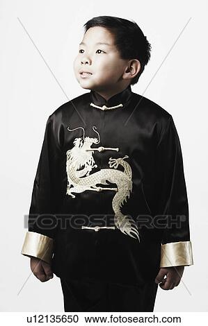 Stock Image - Close-up of a boy looking up thinking. Fotosearch