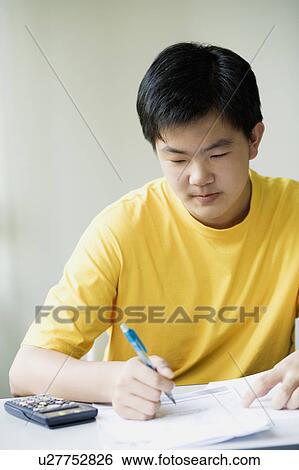 Stock Photograph - Close-up of a boy writing. Fotosearch