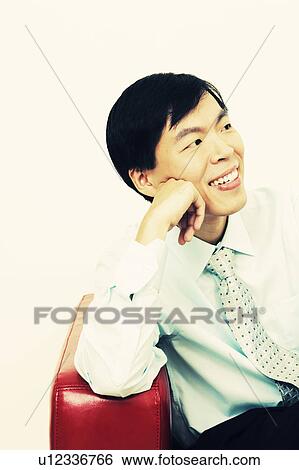 Close-up of a businessman sitting on a couch and thinking View Large Photo Image Stock Photograph - Close-up of a businessman sitting on a couch and thinking. Fotosearch