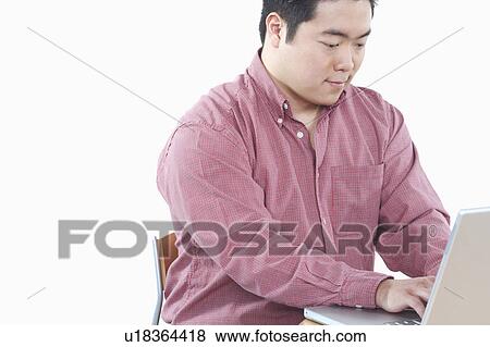 Close-up of a businessman using a laptop View Large Photo Image Stock Photo - Close-up of a businessman using a laptop. Fotosearch