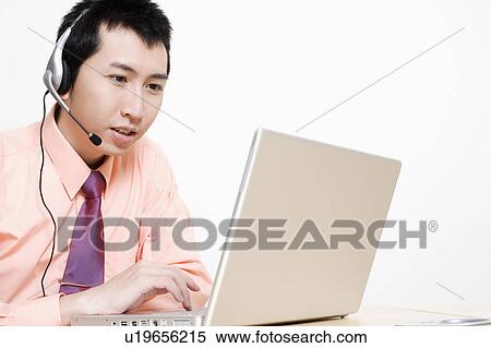 Stock Photography - Close-up of a businessman using a laptop. Fotosearch