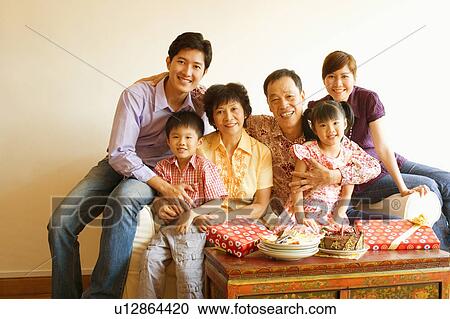Stock Image - Close-up of a family celebrating a birthday party. Fotosearch