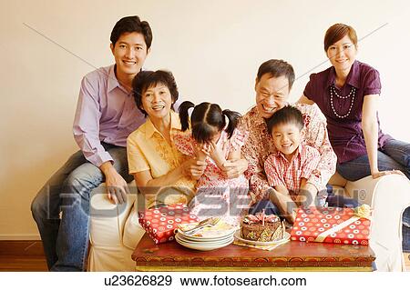 Stock Photo - Close-up of a family celebrating a birthday party. Fotosearch