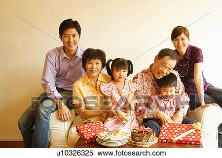 Stock Photography - Close-up of a family celebrating a birthday party. Fotosearch