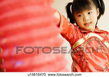 Close-up of a girl holding a Chinese lantern View Large Photo Image Stock Image - Close-up of a girl holding a Chinese lantern. Fotosearch