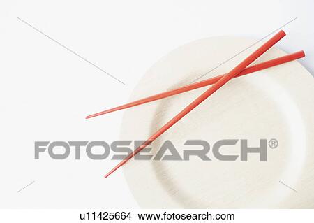 Close-up of a pair of chopsticks on a plate View Large Photo Image Picture - Close-up of a pair of chopsticks on a plate. Fotosearch