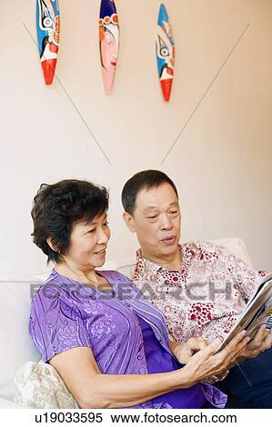 Close-up of a senior man and a mature woman reading a magazine View Large Photo Image Stock Photography - Close-up of a senior man and a mature woman reading a magazine. Fotosearch