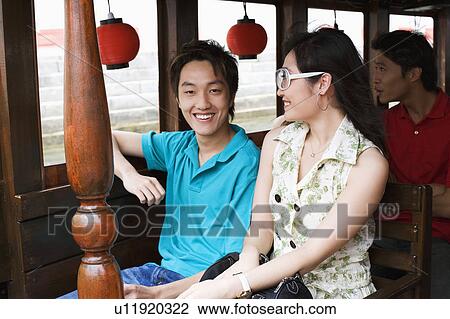 Close-up of a young couple and a young man traveling in a tourboat View Large Photo Image Stock Image - Close-up of a young couple and a young man traveling in a tourboat. Fotosearch