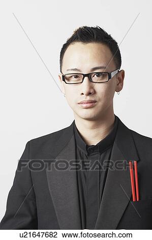 Stock Image - Close-up of a young man with chopsticks in his pocket. Fotosearch