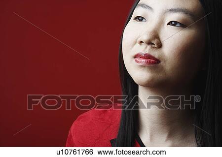 Stock Photograph - Close-up of a young woman looking away. Fotosearch