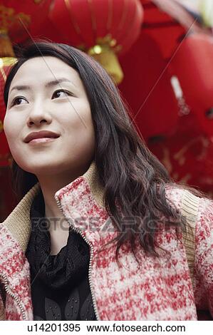 Close-up of a young woman looking away View Large Photo Image Stock Photography - Close-up of a young woman looking away. Fotosearch