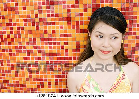 Stock Image - Close-up of a young woman making a face. Fotosearch