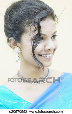 Stock Image - Close-up of a young woman smiling. Fotosearch