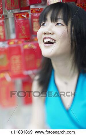 Close-up of a young woman smiling View Large Photo Image Stock Photo - Close-up of a young woman smiling. Fotosearch