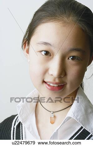 Close-up of a young woman smiling View Large Photo Image Stock Photo - Close-up of a young woman smiling. Fotosearch