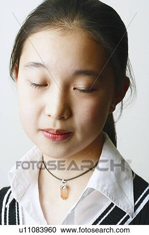 Close-up of a young woman with her eyes closed View Large Photo Image Stock Image - Close-up of a young woman with her eyes closed. Fotosearch