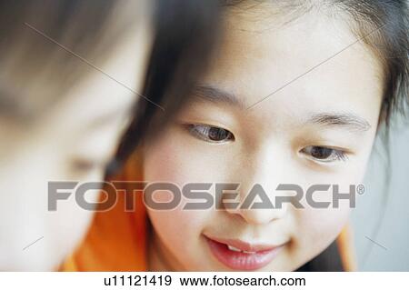 Close-up of two girls View Large Photo Image Stock Photo - Close-up of two girls. Fotosearch