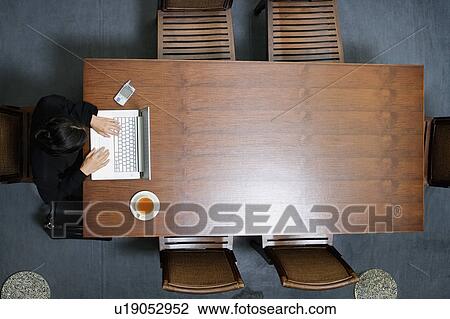 Stock Image - High angle view of a businesswoman using a laptop. Fotosearch
