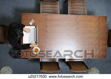 High angle view of a businesswoman using a laptop View Large Photo Image Stock Image - High angle view of a businesswoman using a laptop. Fotosearch